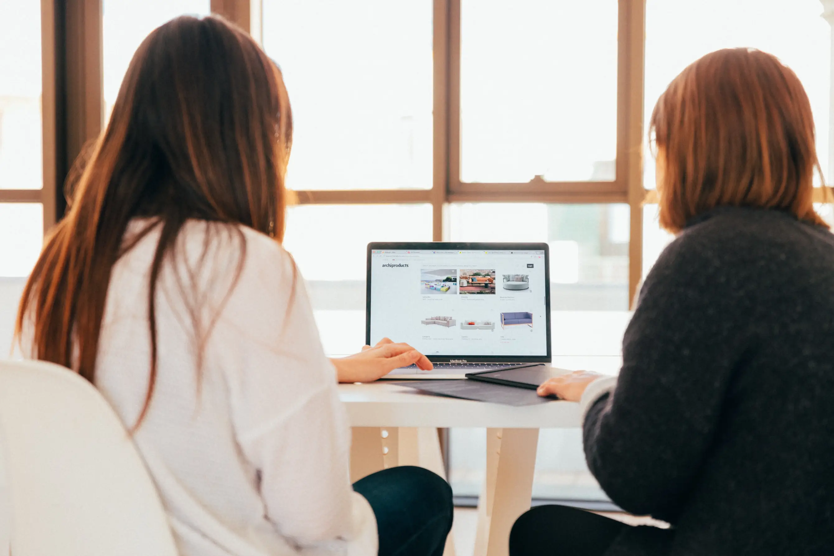 Two persons making a website for an online business